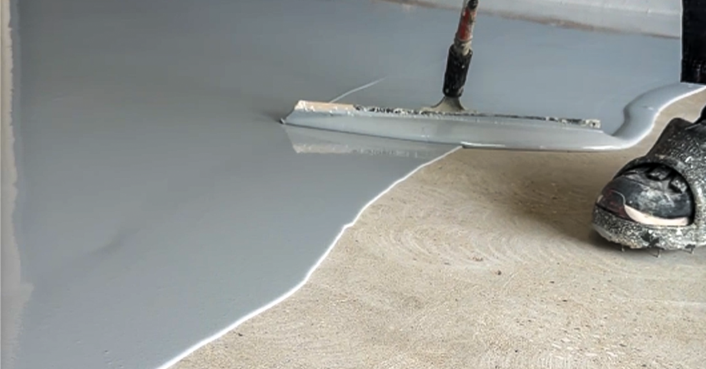 Spreading-Epoxy-Paint-on-Garage-Floor