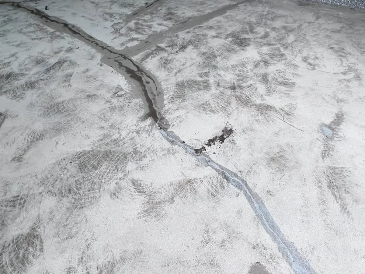 Signed installation warranty document on a finished Houston garage floor