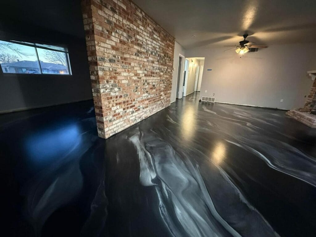 Black and white marbled metallic floor beside a brick wall