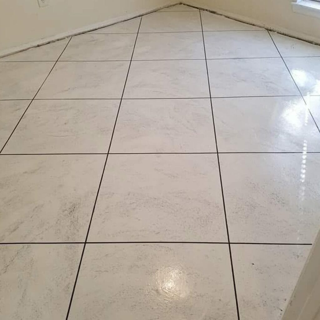 White concrete overlay scored to look like large tiles