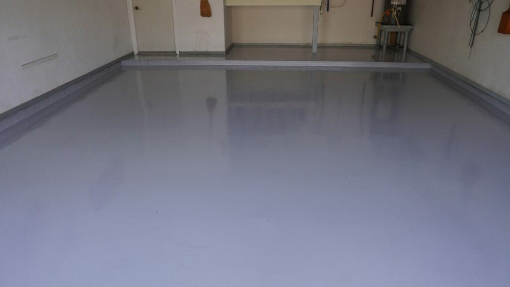 Solid gray epoxy garage floor with a glossy finish