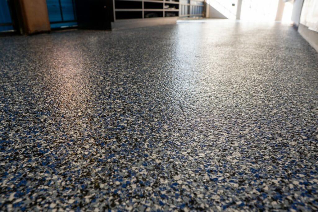 Close-up of a gray speckled flake floor under a gloss topcoat