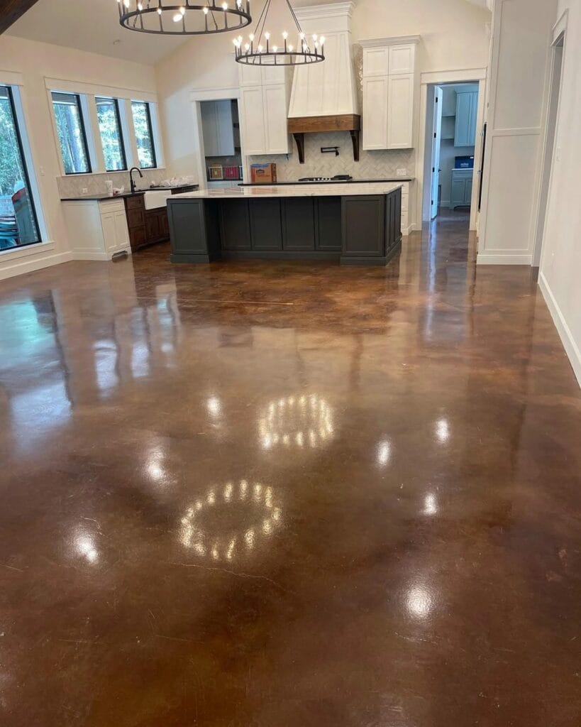 Brown stained and sealed concrete floor in an open kitchen